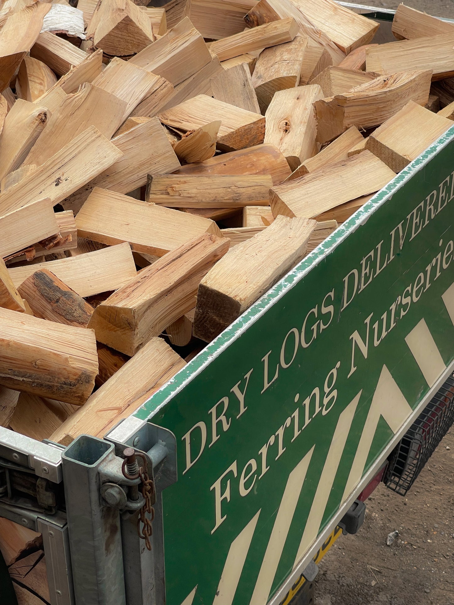 A closeup rear view of our half load of seasoned firewood loaded into our local delivery van.