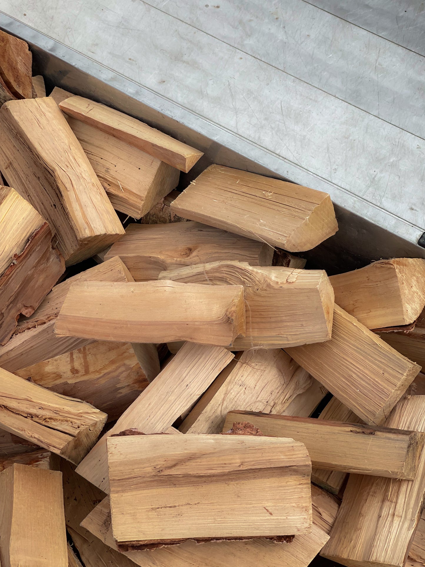A closeup front view of our half load of seasoned firewood loaded into our local delivery van.