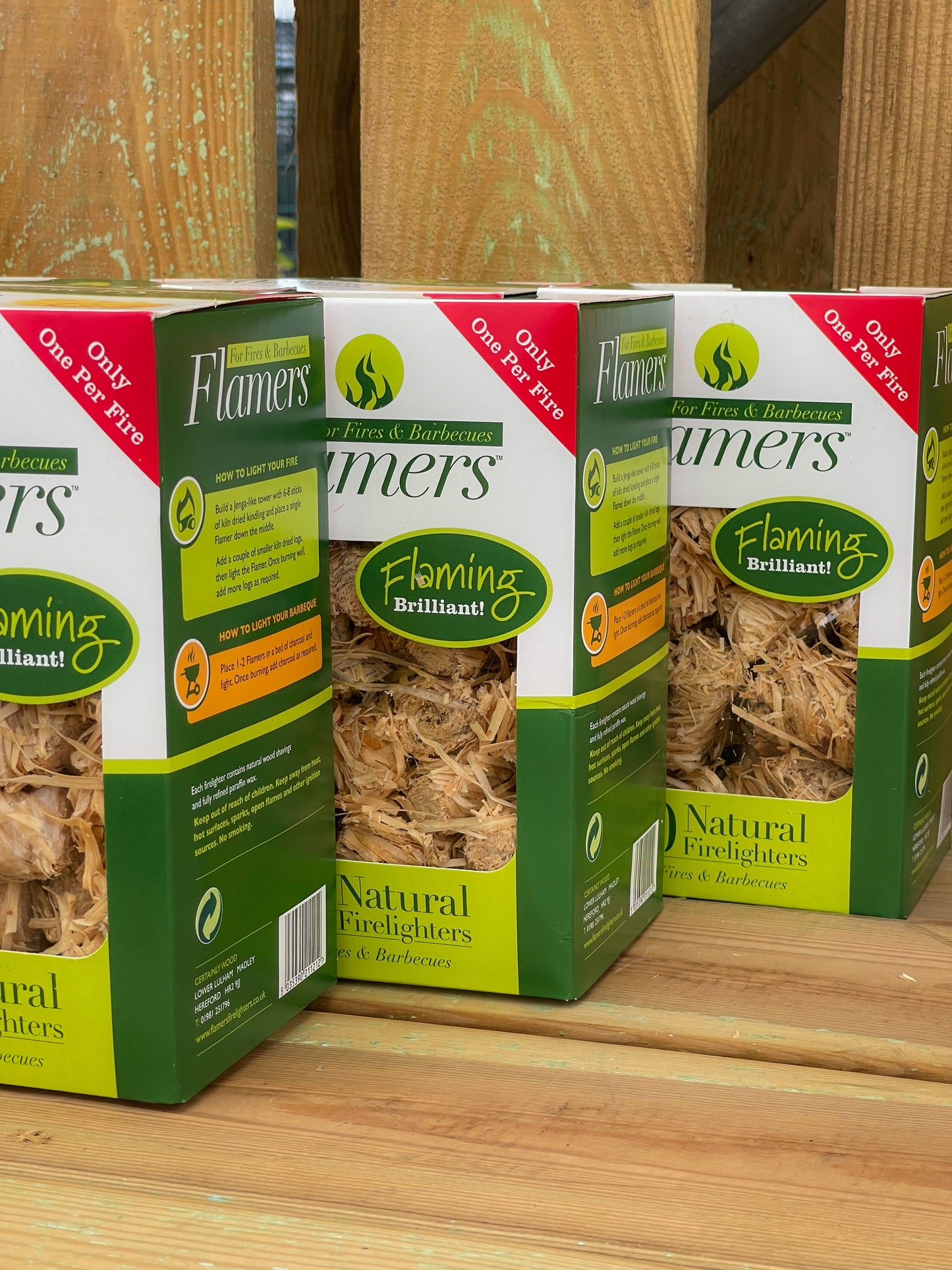 front view of three boxes of Flamer Firelighters on display