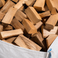 Close up of seasoned hardwood logs filling a Ferring Firewood bulk bag.