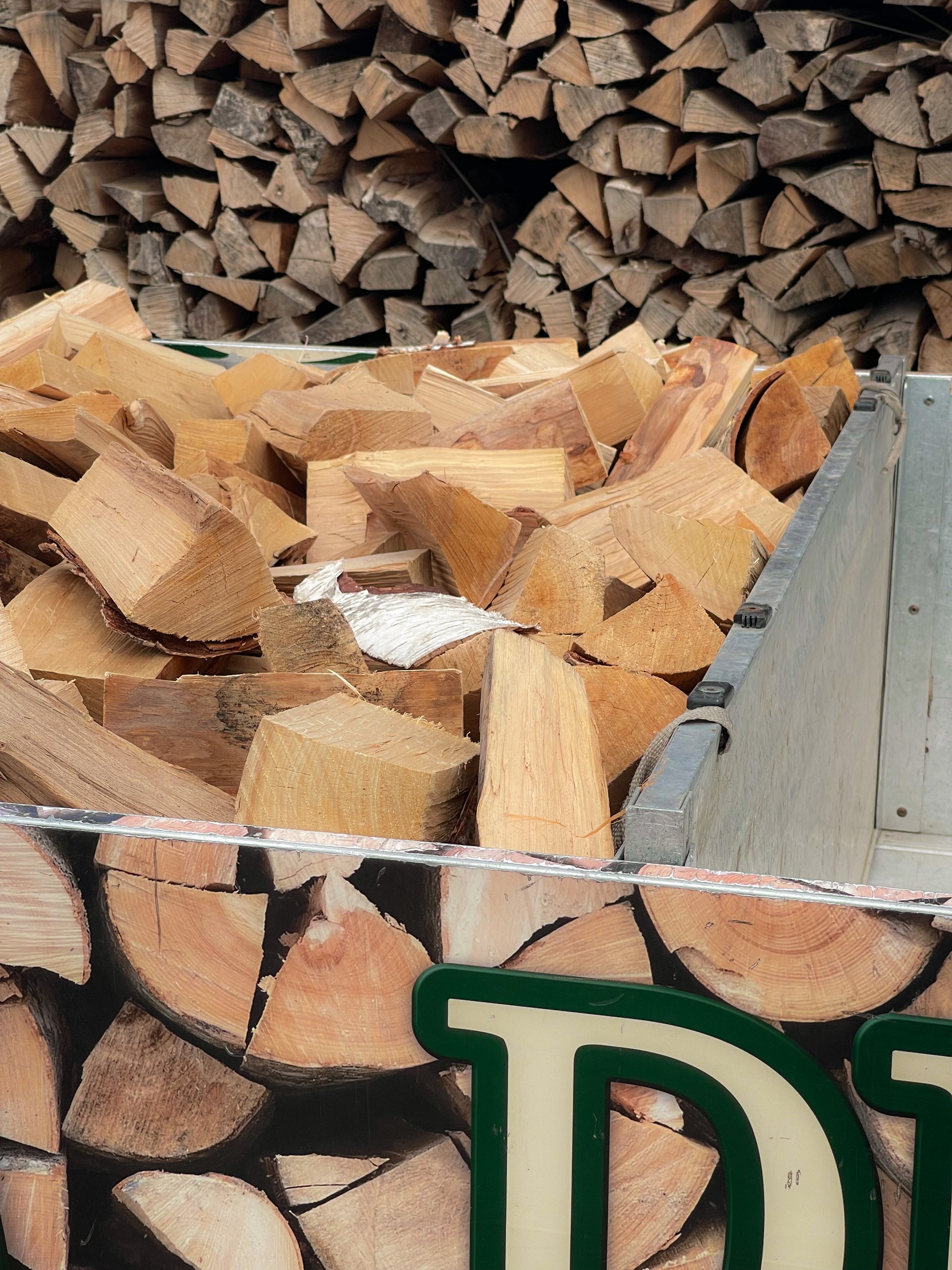 A closeup side view of our half load of seasoned firewood loaded into our local delivery van.